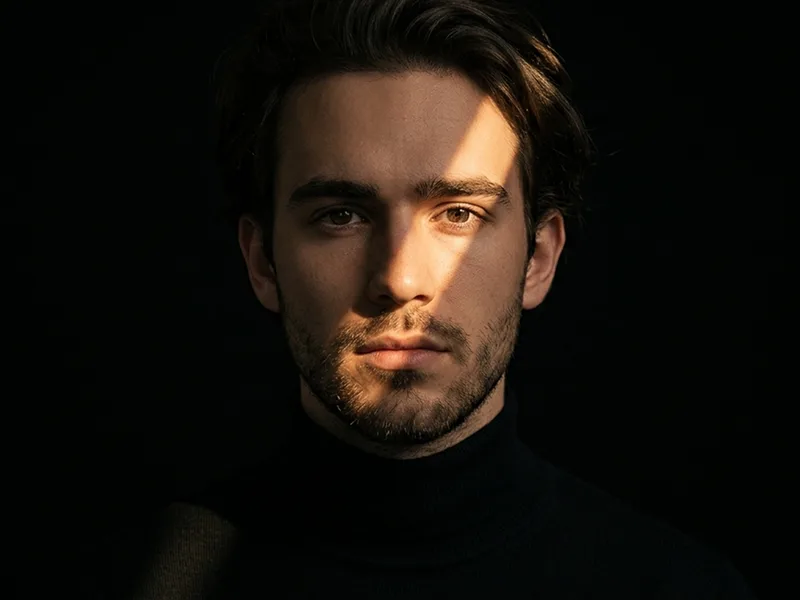 Diagonal Golden Beam Low-Key Cinematic Portrait Prompt - Gemini Prompt