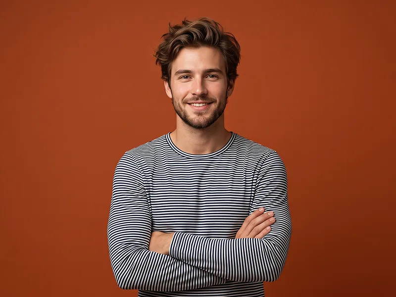 Crossed-Arms Orange Studio Portrait With Striped Shirt Prompt - Gemini Prompt